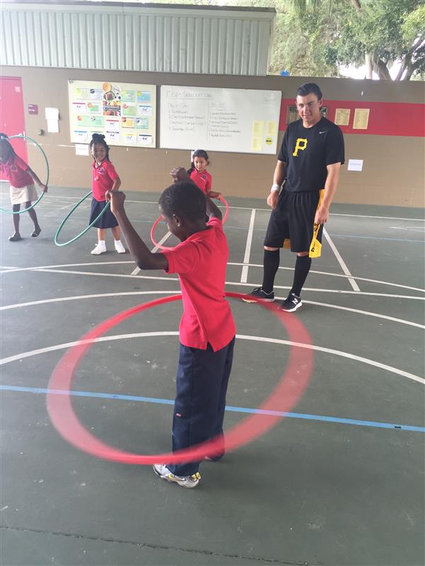 students and Pirates players using hula hoops